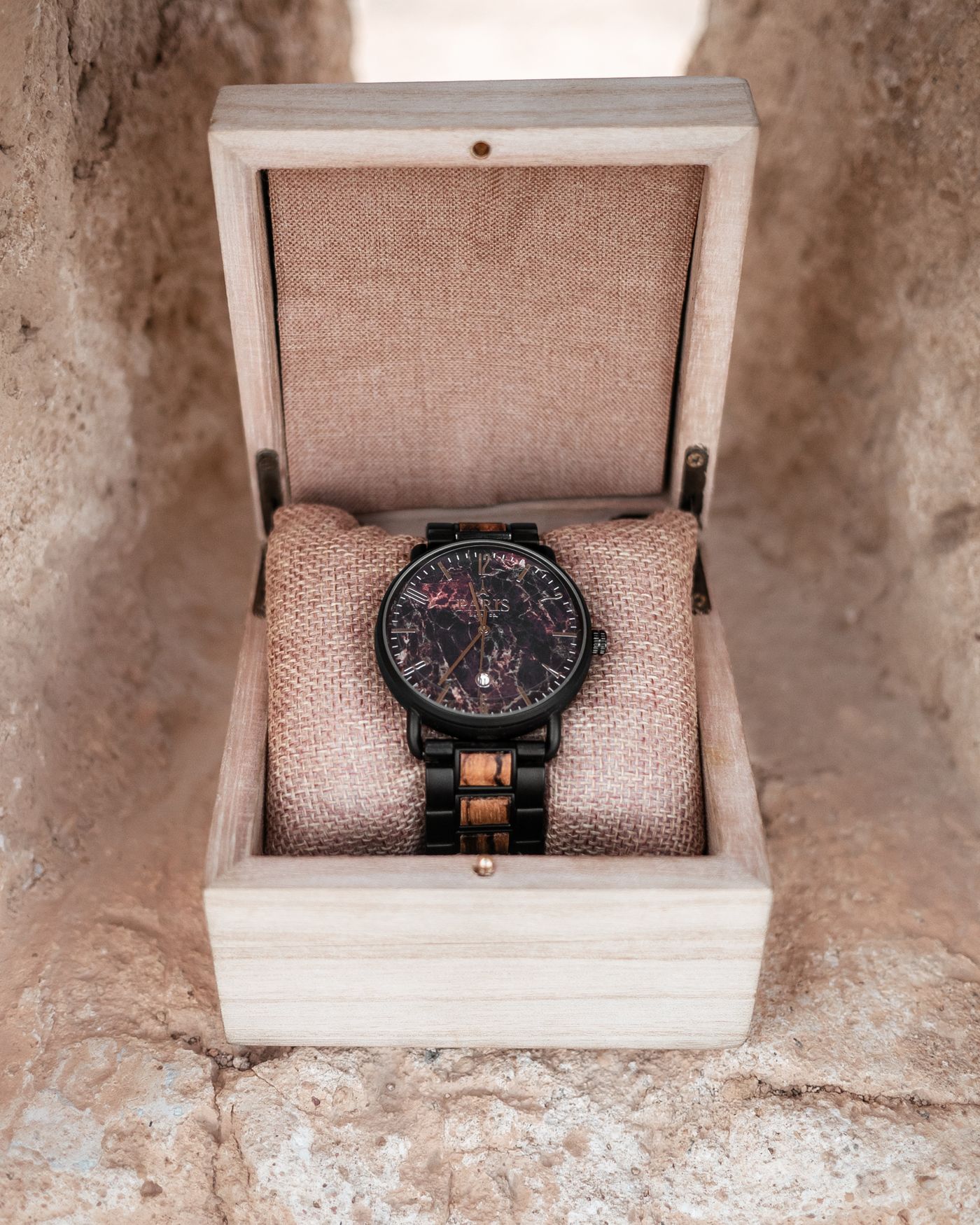 A wristwatch cushioned in its own lined wooden box